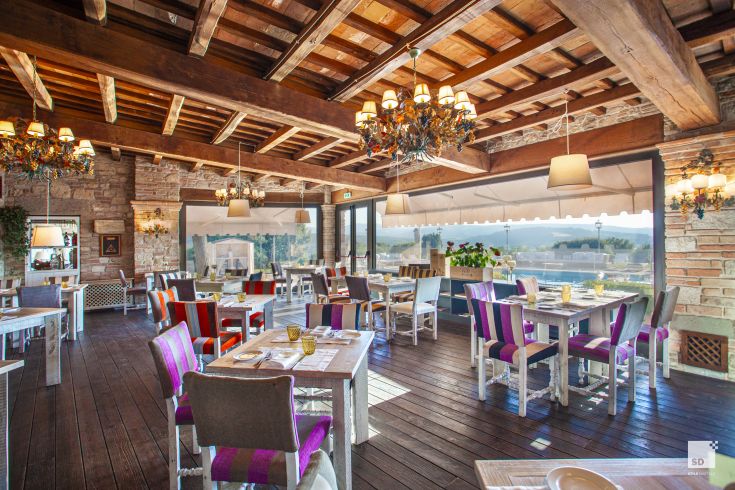 Restaurant located in the Umbrian countryside, featuring a mix of modern and traditional furnishings.