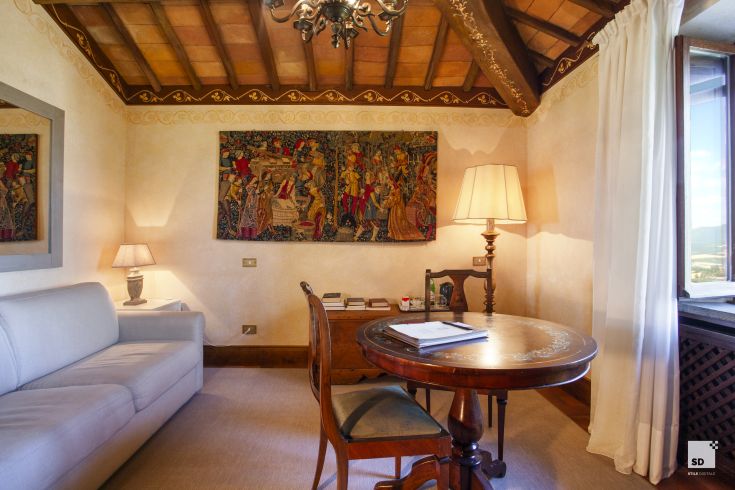 Interior of a palace in Umbria featuring simple furnishings and details reflecting the region's tradition.