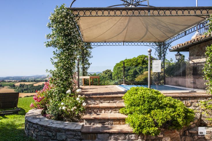 Relax in this peaceful space surrounded by nature, featuring a view of the Umbrian countryside.