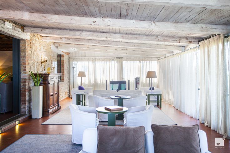 Cozy interior of Palazzo Todini, featuring simple furnishings and overall brightness.