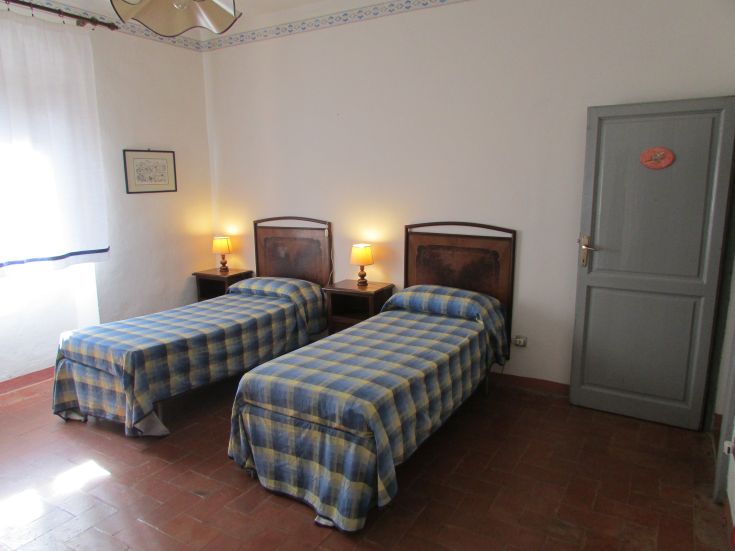 Room with two single beds, perfect for a peaceful stay in a rural setting.