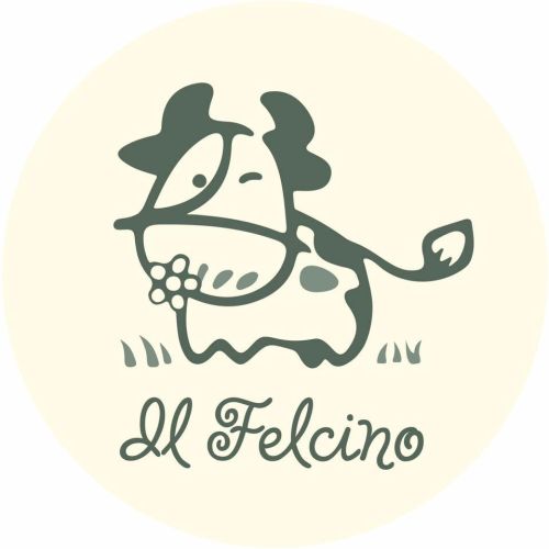Logo of a farmhouse featuring a smiling cow, symbolizing hospitality and fresh produce.