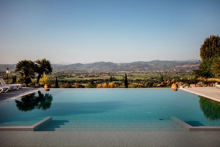 Swimming pool in a peaceful green setting, overlooking the stunning views of Assisi.