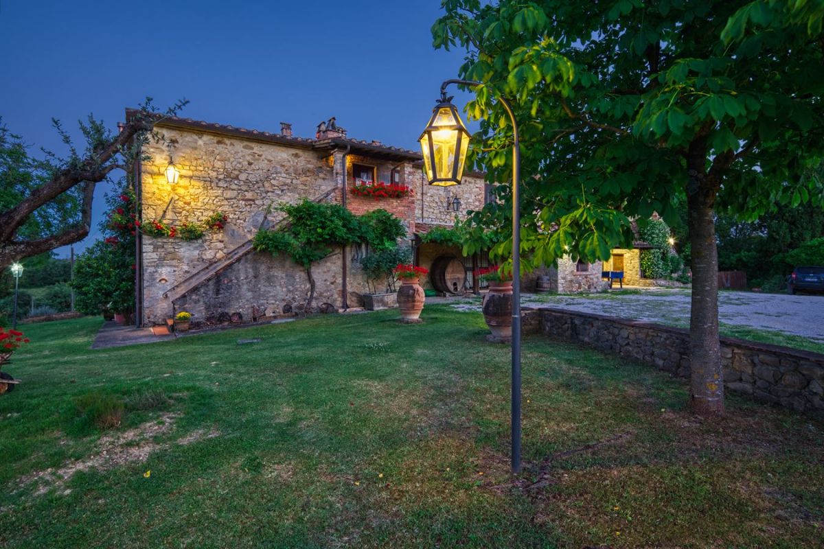 A countryside guesthouse in Umbria, surrounded by greenery, offering a cozy and relaxing atmosphere, perfect for a getaway.
