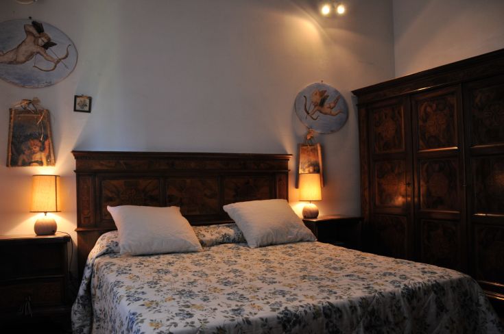 A simple bedroom with a double bed and minimal decor, perfect for a serene stay.