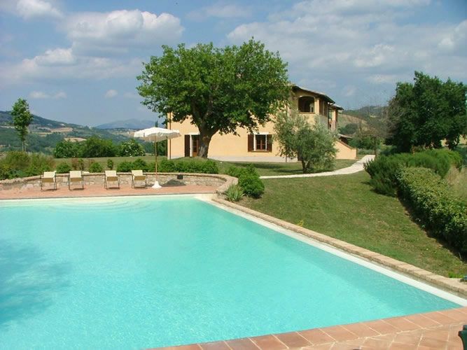 A peaceful vacation home in Umbria, surrounded by nature and featuring an outdoor swimming pool.