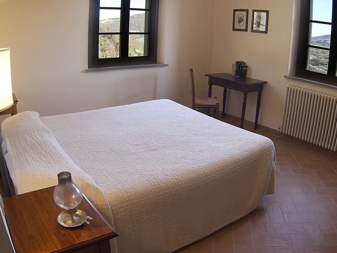 Spacious and comfortable room with a double bed and wooden decor, perfect for a relaxing stay.