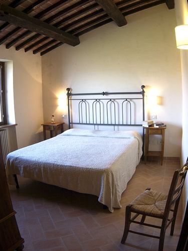 Cozy space with a double bed and wooden furniture. Perfect for a relaxing stay.