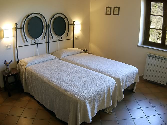 Simple room with single beds, cozy decor, perfect for relaxation during your stay.