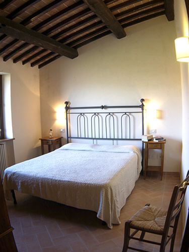 Cozy bedroom with a double bed and light wood furniture, perfect for a relaxing retreat.