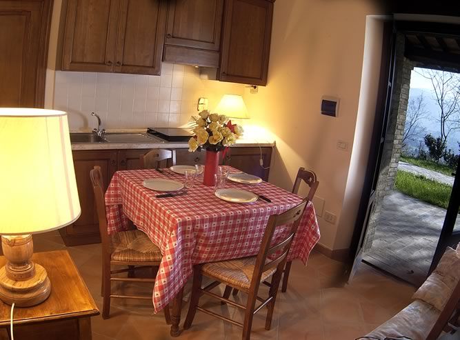 Cozy Umbrian kitchen with a well-set table and a view of the surrounding nature.