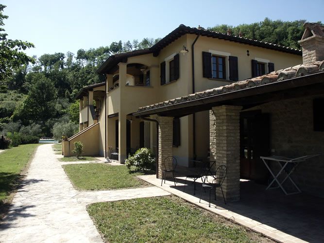 Cozy vacation home surrounded by olive groves and woods, perfect for a peaceful retreat in nature.