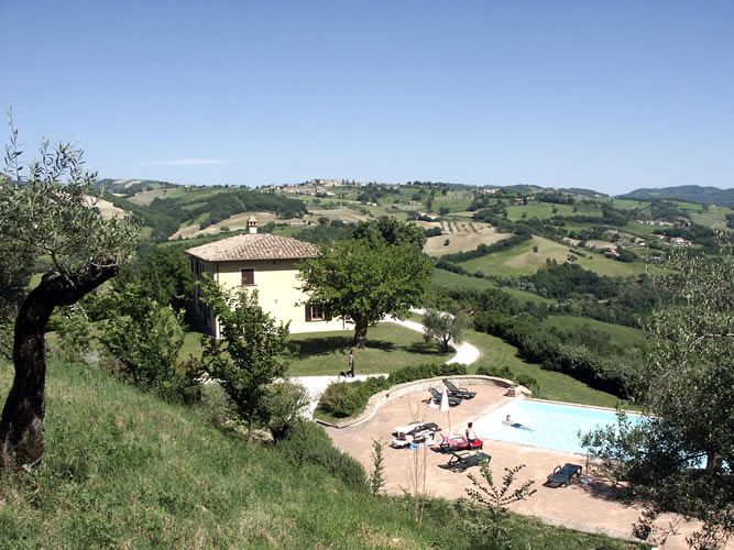 Holiday home surrounded by Umbrian hills, featuring a pool and olive groves, offering a stunning view.