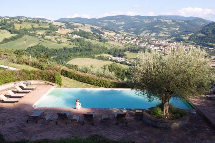 Moments of tranquility by the swimming pool, surrounded by gentle Umbrian hills.