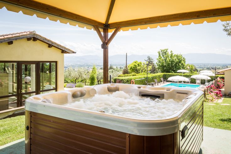 Jacuzzi surrounded by a tranquil green landscape, perfect for relaxation.