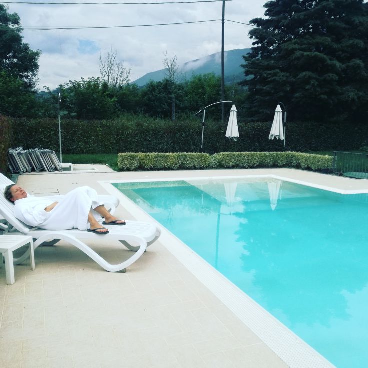 A moment of relaxation by the pool, surrounded by a serene and natural setting.