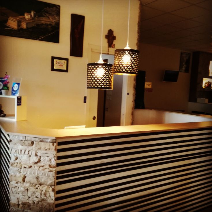 Cozy reception area with simple lighting and modest decorations.