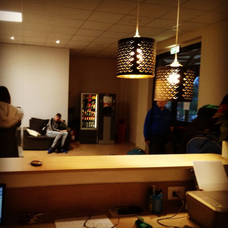 A cozy environment with comfortable chairs, vending machines, and modern lighting.