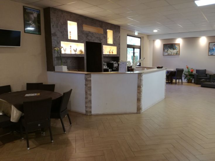 Interior of a building featuring a reception area and a relaxing space.