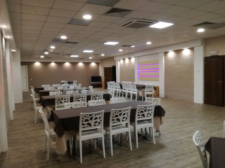 Elegant indoor space with tables and chairs arranged for meetings or events.