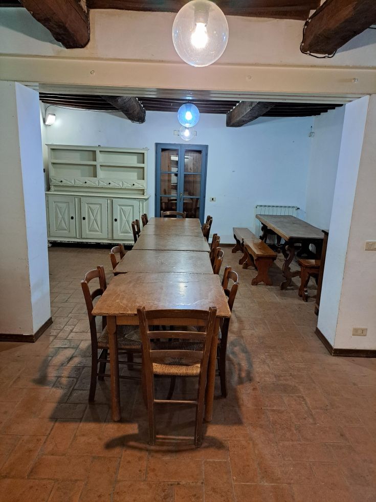 Spazio invitante con tavoli in legno, ideale per incontri e momenti di convivialità.