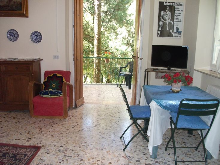 Serene environment with access to a balcony overlooking a garden. Bright and relaxing atmosphere.
