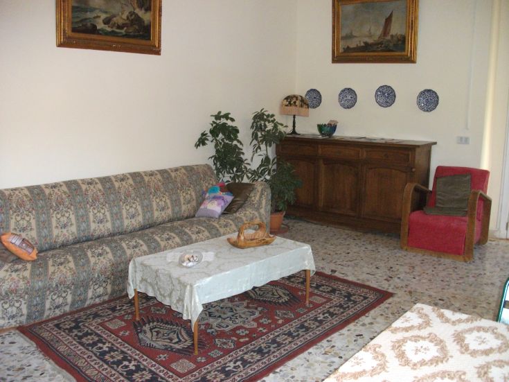 Comfortable living room with a sofa, coffee table, and wall decorations. Relaxing and pleasant atmosphere.
