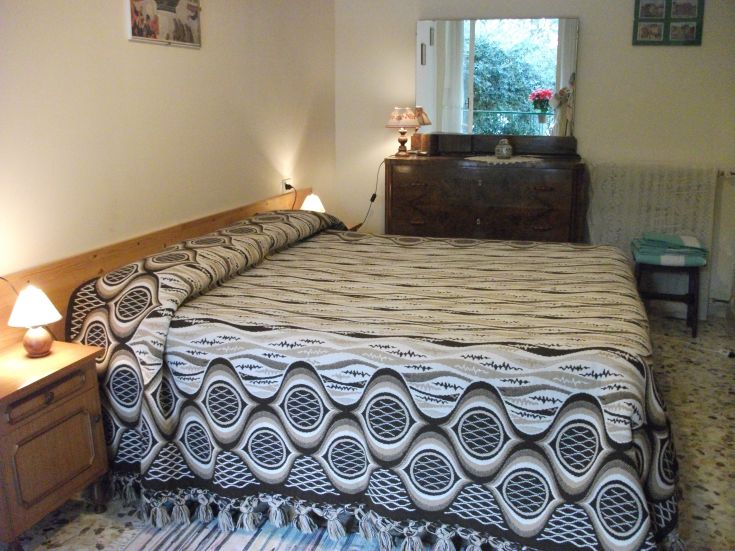 Spacious and bright master bedroom, featuring well-organized beds for comfort.