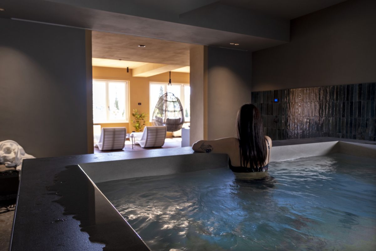 A serene atmosphere in a modern spa, with large windows offering views of the surrounding greenery.