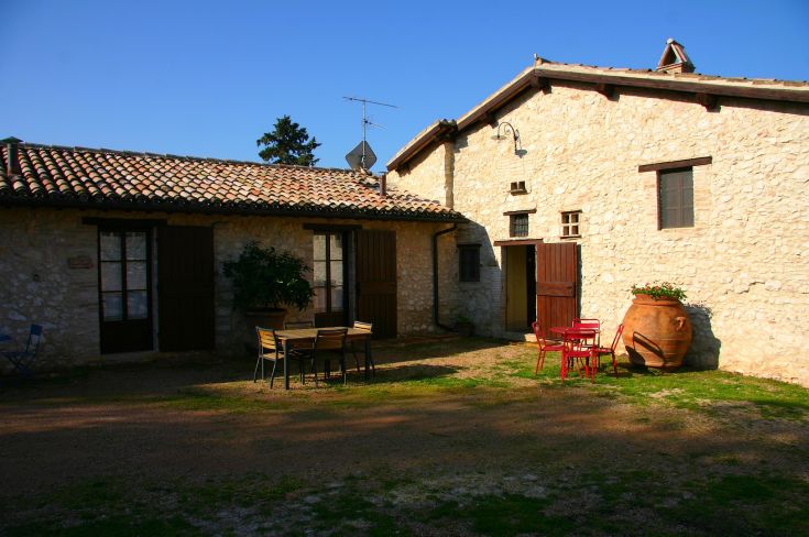 Image of a rustic farmhouse featuring a wooden entrance and a cozy, rustic atmosphere.