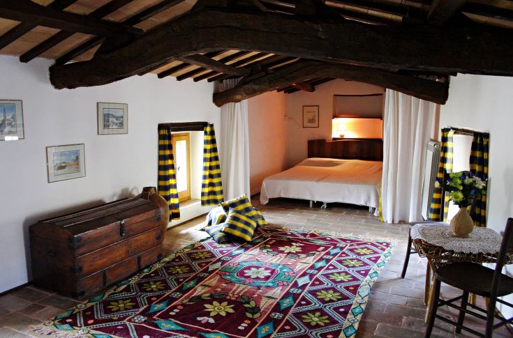 Spacious room with simple decor, offering a comfortable atmosphere perfect for relaxation.