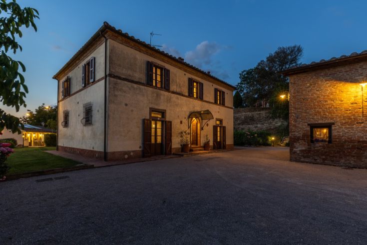 Historic restored building in the Umbrian countryside, surrounded by a peaceful natural environment.