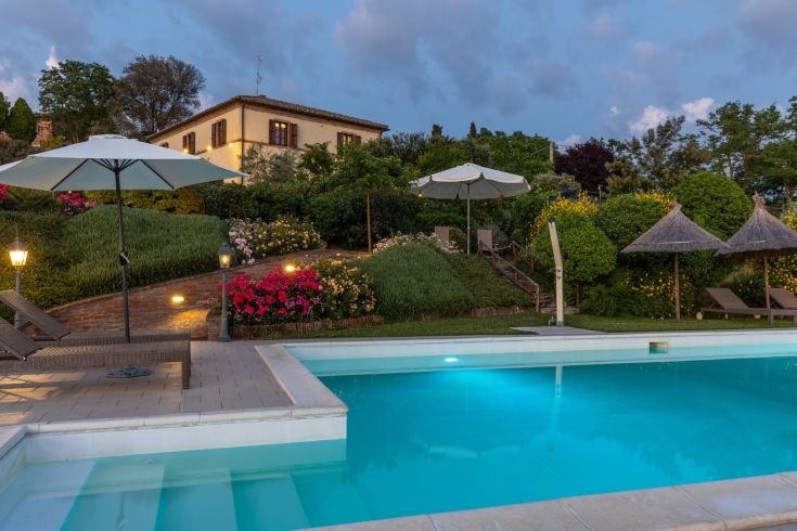 Farmhouse with a pool surrounded by gardens and stunning views of the countryside.