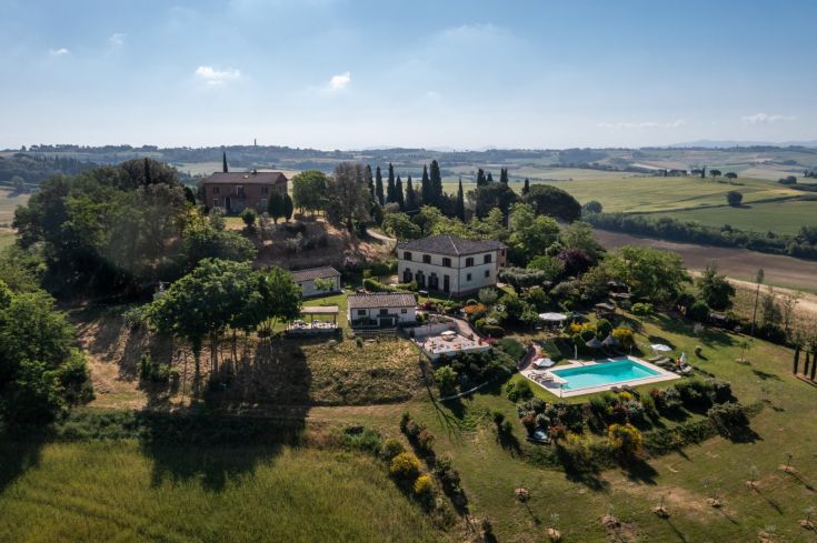A tranquil agriturismo in the Umbrian countryside, surrounded by olive groves and featuring a pool.