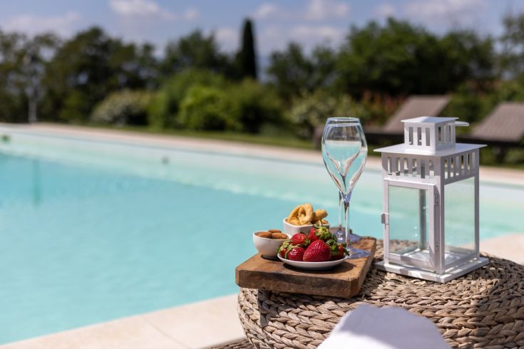 A relaxing moment by the pool with fresh fruit and a peaceful view.