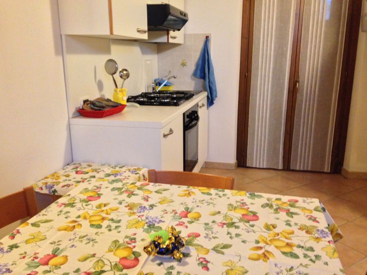 Einfache und gemütliche Küche, ideal für Familienmahlzeiten und gesellige Zusammenkünfte.