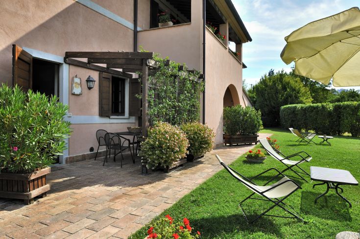A peaceful agriturismo surrounded by nature, featuring a garden and outdoor relaxation areas.