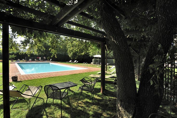Agriturismo with a private pool surrounded by lush green spaces, perfect for relaxation.