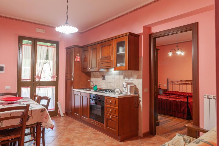 Appartamento confortevole con cucina in legno e panorama su un ambiente naturale.