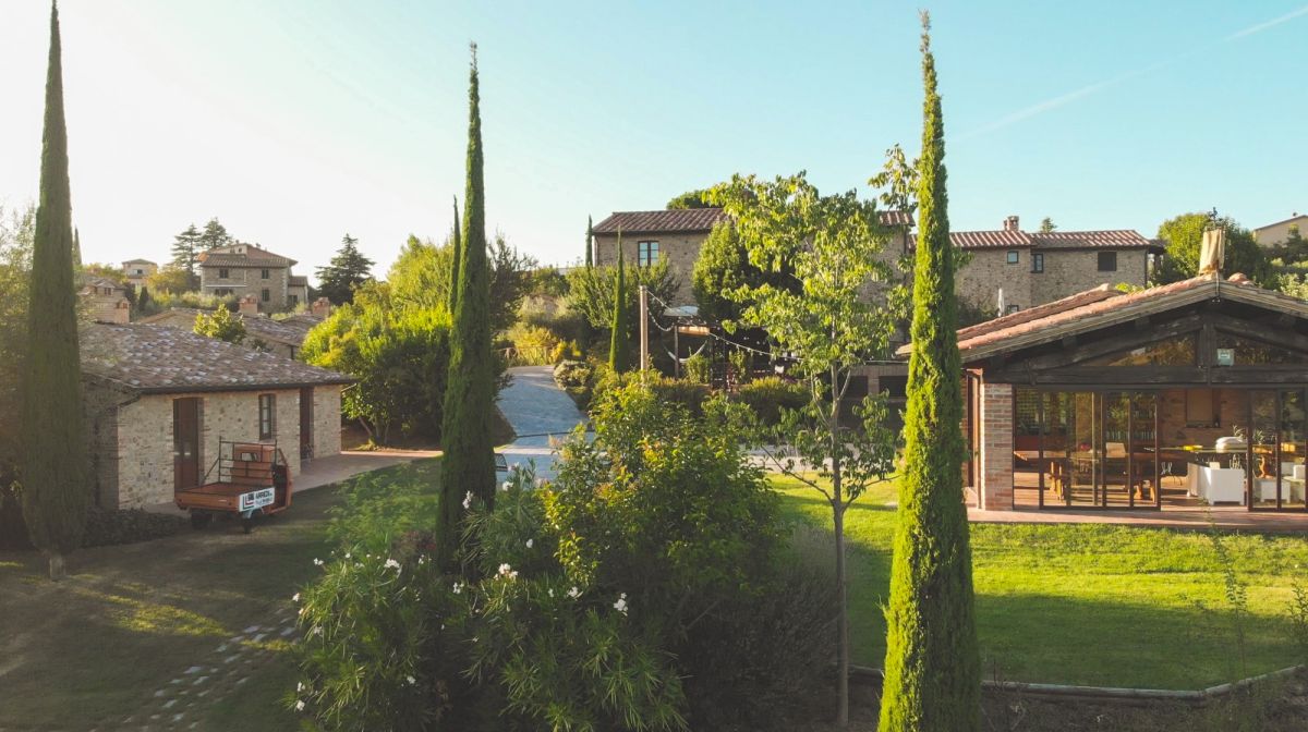 Scenic view of charming cottages in the Borgo Vacanze PanElios, surrounded by lush greenery.