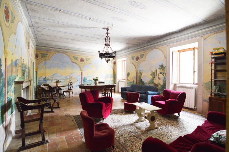 Cozy agriturismo interior featuring wall decorations, traditional furniture, and a family-friendly atmosphere.