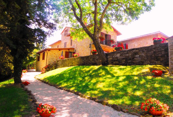 Cozy agriturismo surrounded by greenery, offering beautiful views and relaxing spaces.