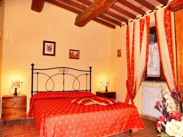 Family room with double bed, wooden details, and soft lighting.