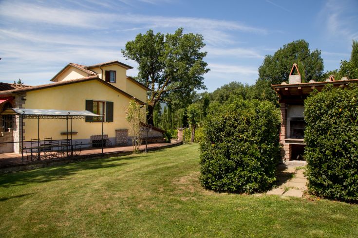 Eine von Grün umgebene Villa mit Garten und Schwimmbad, ideal für Familien und Gruppen.