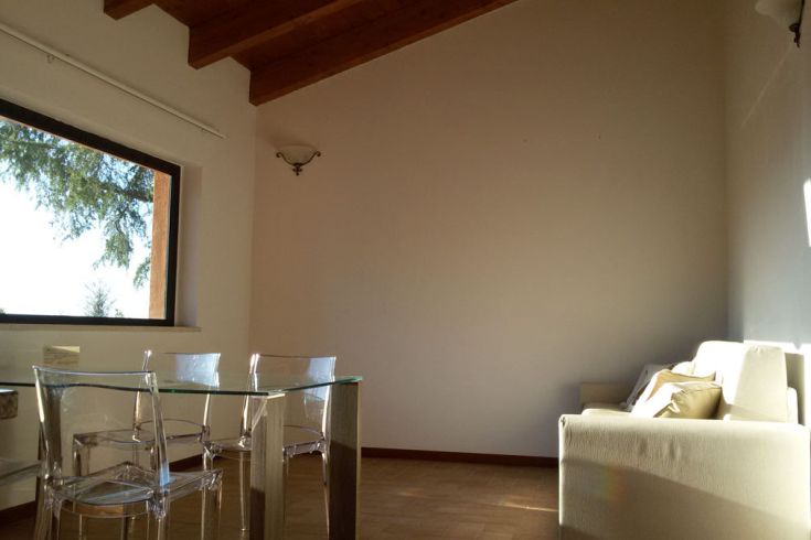 Helles Interieur mit Fenster und schlichten Möbeln, das eine angenehme Atmosphäre schafft.