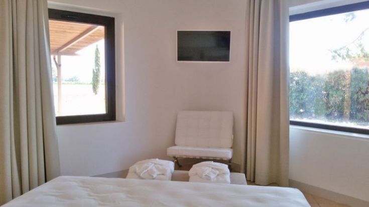 Einfaches Zimmerinterieur mit Betten und Fenstern, die Licht hereinlassen.