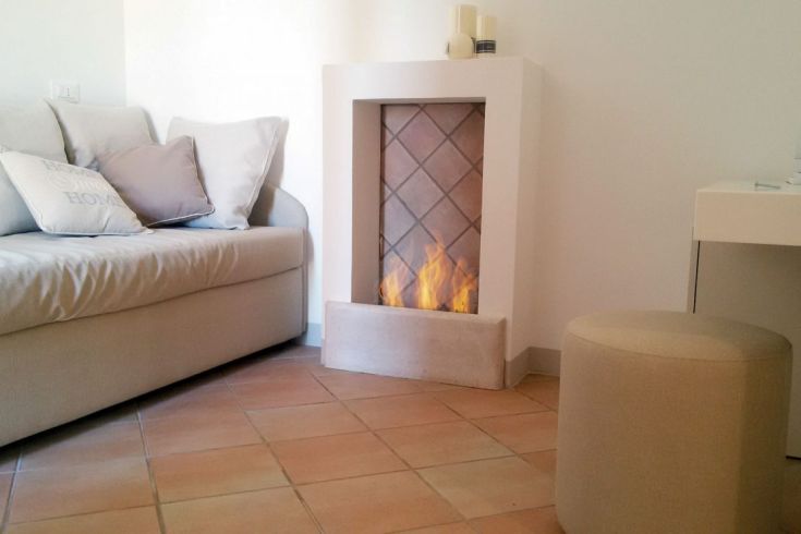 Ein einfaches Wohnzimmer mit einem Sofa und einem Kamin, ideal zum Entspannen.