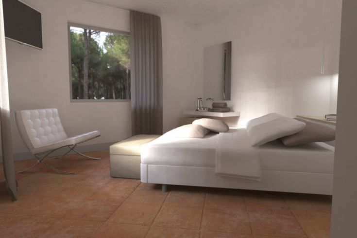 Ein hell beleuchteter Raum mit einfachen Möbeln und einem Fenster, das auf eine natürliche Umgebung blickt.