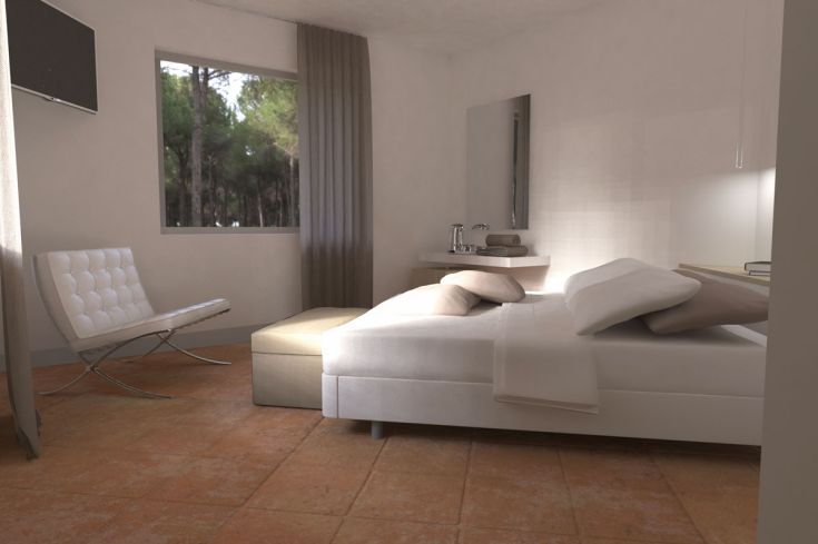 Geräumiges Schlafzimmer, einfach eingerichtet, mit Aussicht auf eine naturnahe Landschaft.