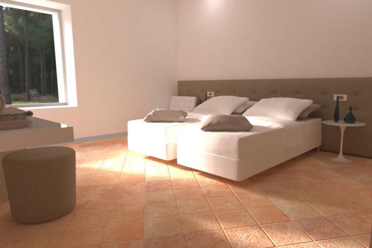 Gut beleuchteter Raum mit Einzelbetten und einfachen Möbeln.